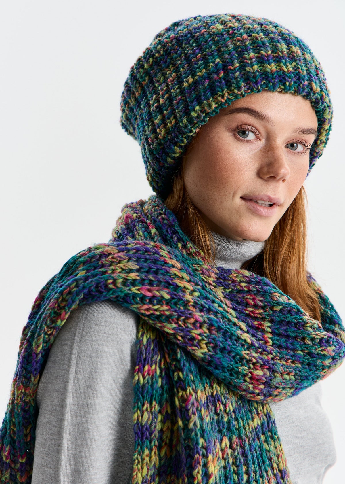 BRIKOLY London Lilac & Navy knit beanie shown close up on a model looking back.