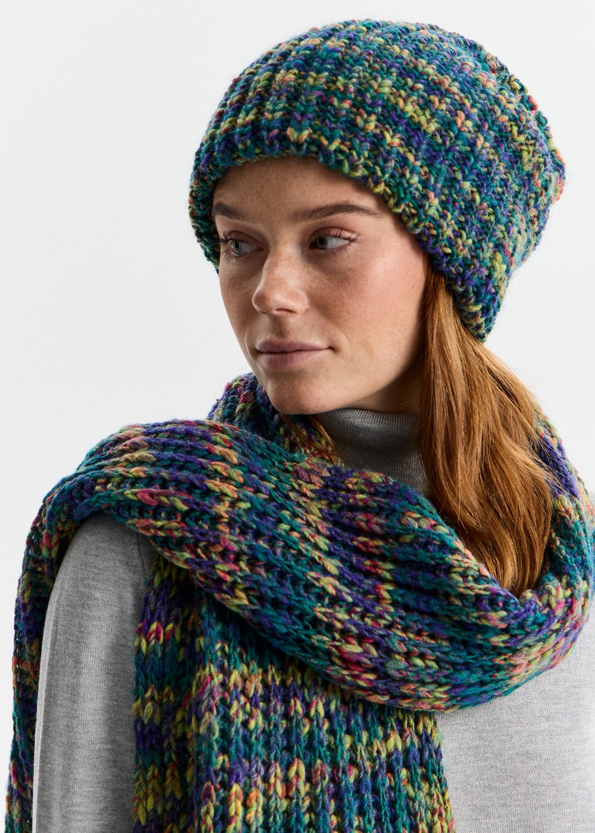 BRIKOLY London Lilac & Navy knit beanie shown on a model looking to the side with a matching scarf.