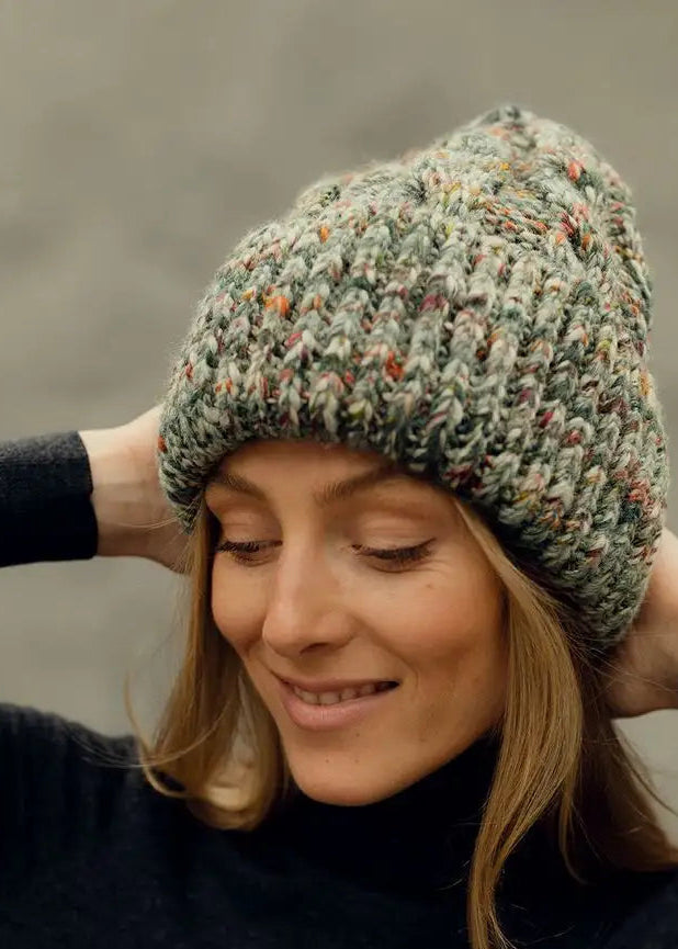 Tokyo Green cable knit wool beanie: Three-quarter smiling portrait