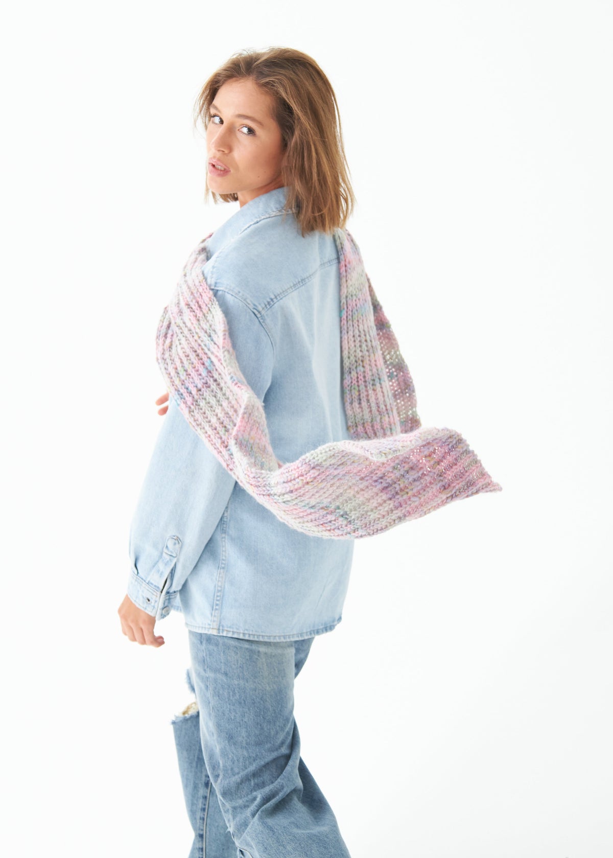 Oversized Unicorn alpaca-wool scarf: Rear side outfit view with one end held out; beanie sold separately