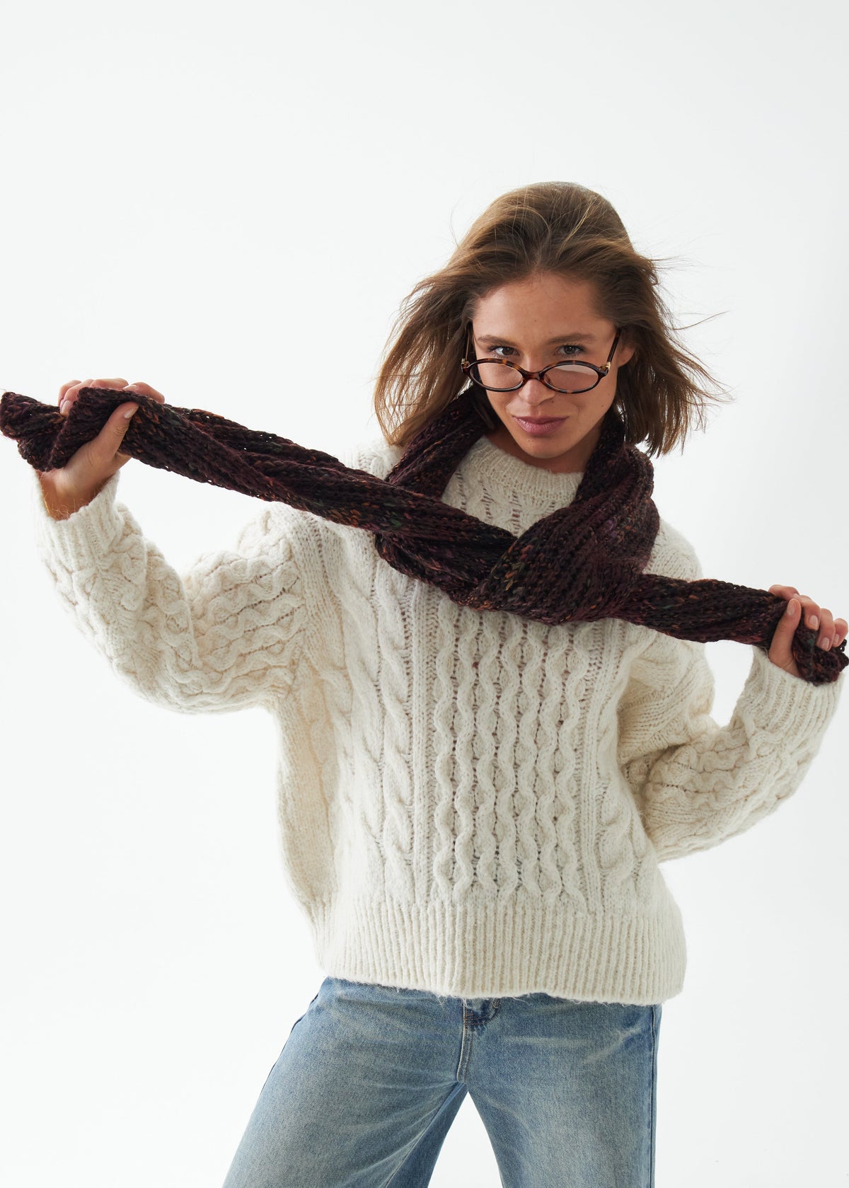 Oversized Maroon & Black alpaca-wool scarf: Front outfit view holding both scarf ends; beanie sold separately