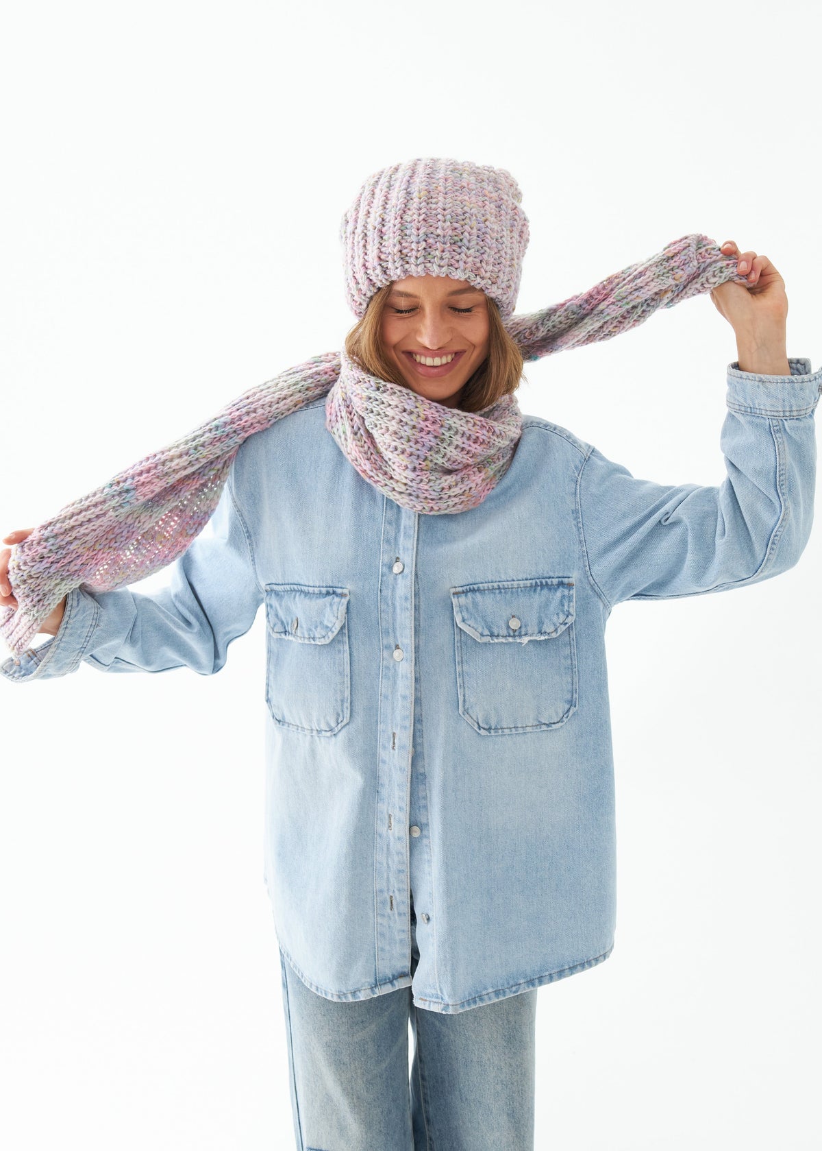 Oversized Unicorn alpaca-wool scarf: Playful outfit view with scarf held around the neck; beanie sold separately