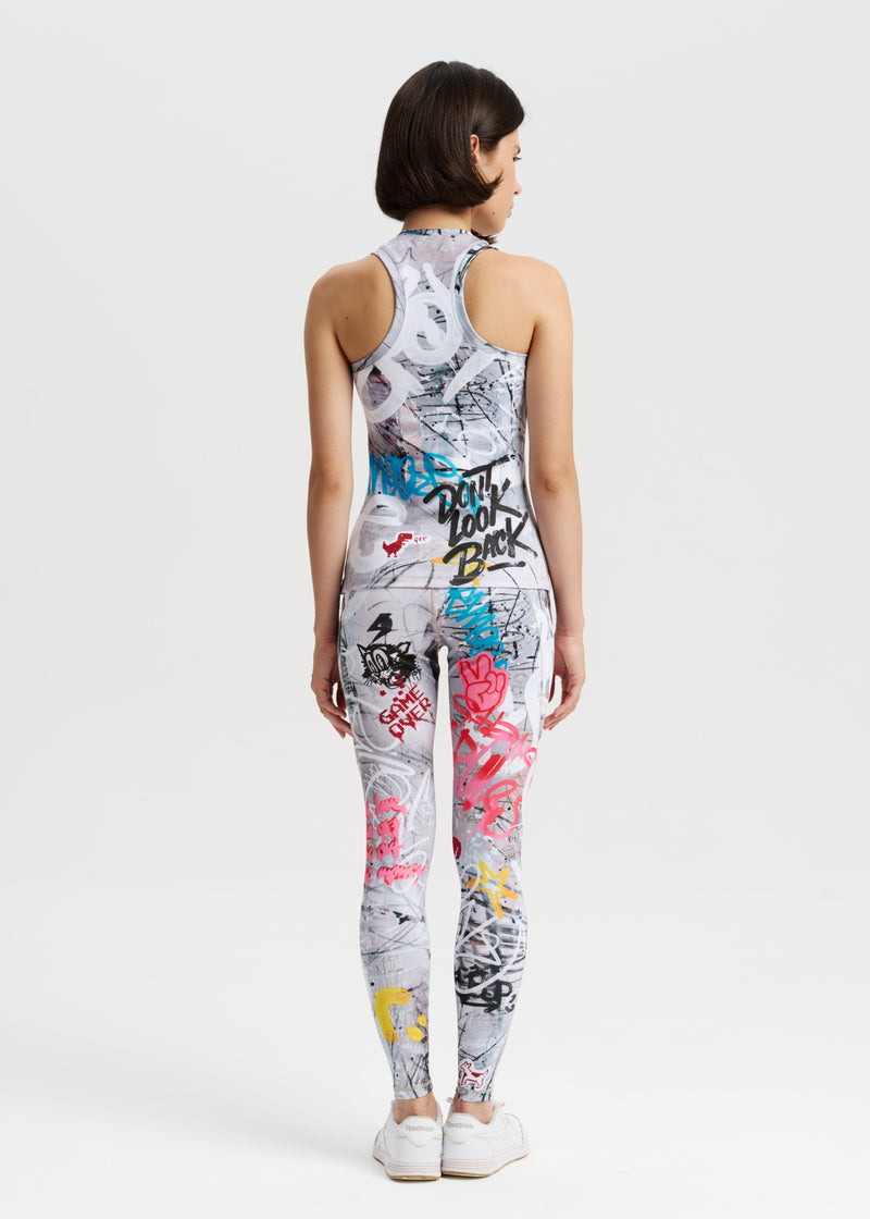 Person wearing a sleeveless top and leggings with colorful graffiti design on a white background