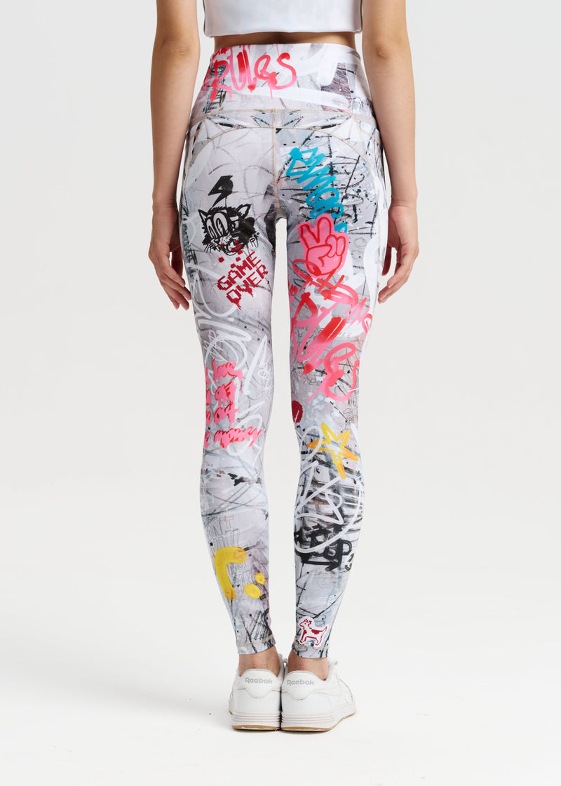 Person wearing colorful graffiti-style leggings on a white background