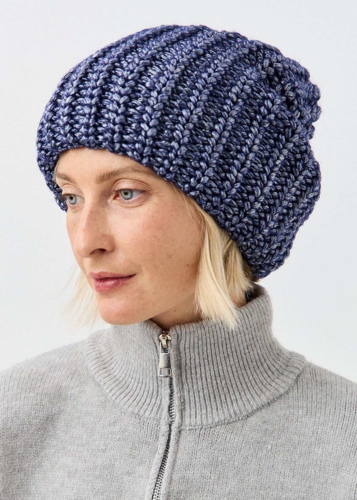 BRIKOLY Lustre Denim Melange oversized knit beanie shown in a close three-quarter view.