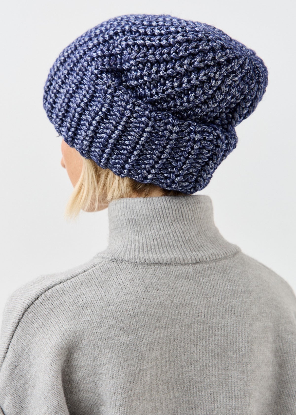 BRIKOLY Lustre Denim Melange oversized knit beanie shown from the rear side.