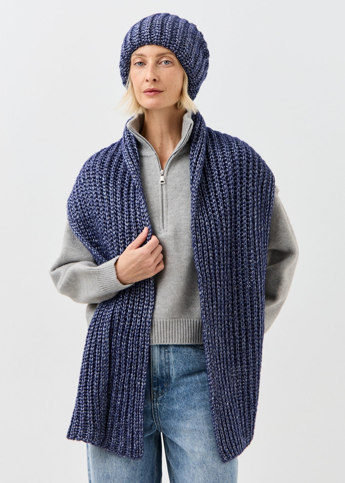 Lustre Denim Melange alpaca-wool scarf: Front view with one hand holding the scarf; beanie sold separately