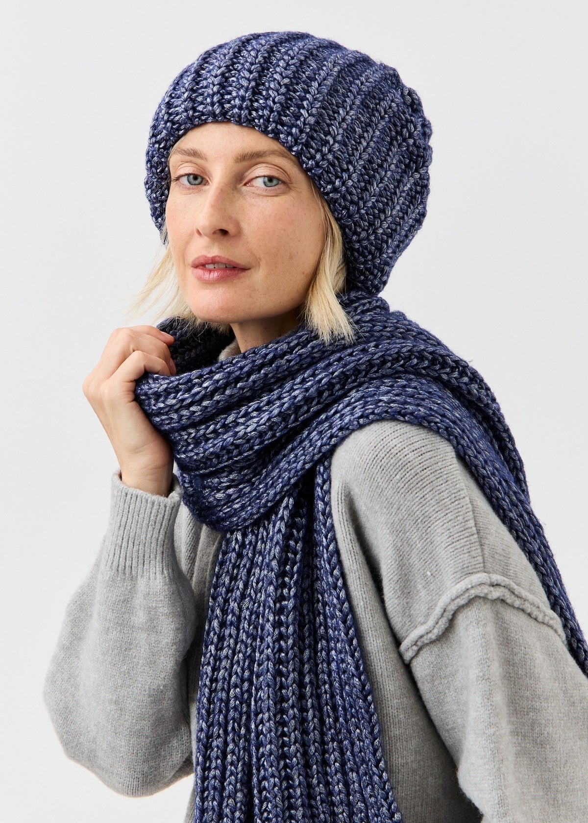 Lustre Denim Melange alpaca-wool scarf: Front close-up with a hand at the scarf; beanie sold separately