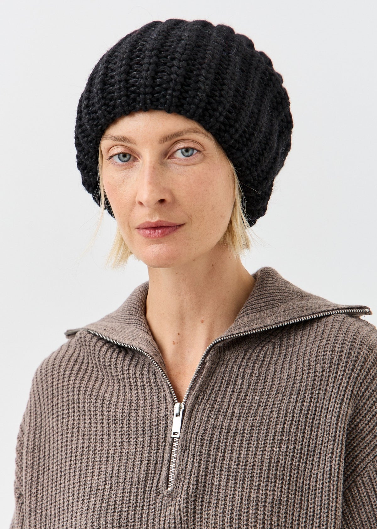 BRIKOLY Lustre Black Melange oversized knit beanie shown in a front view on a model.