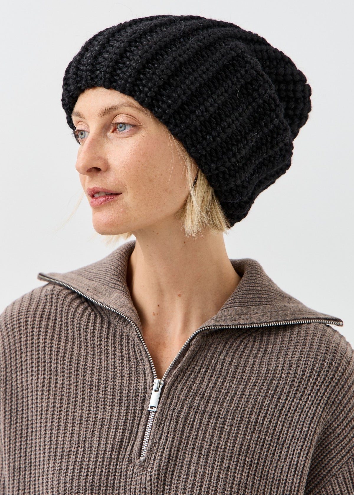 BRIKOLY Lustre Black Melange oversized knit beanie shown in a three-quarter view.