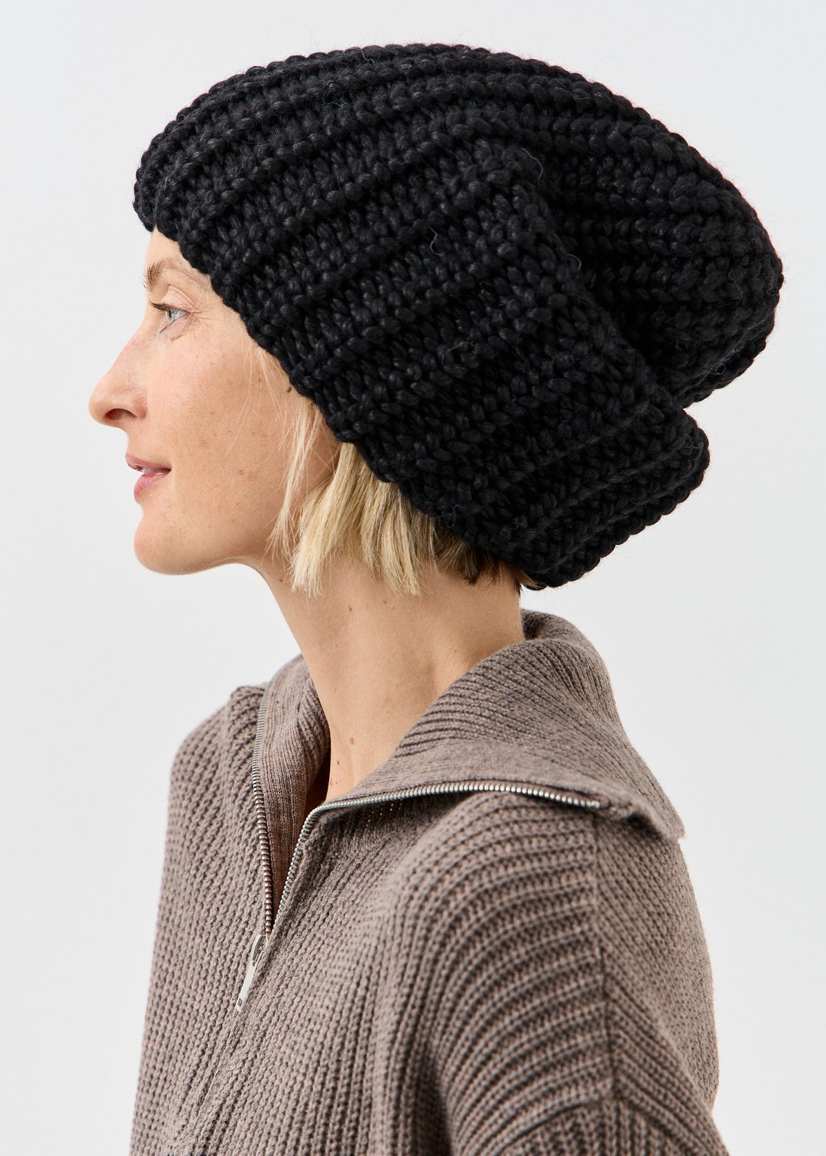 BRIKOLY Lustre Black Melange oversized knit beanie shown in profile to reveal its relaxed crown.