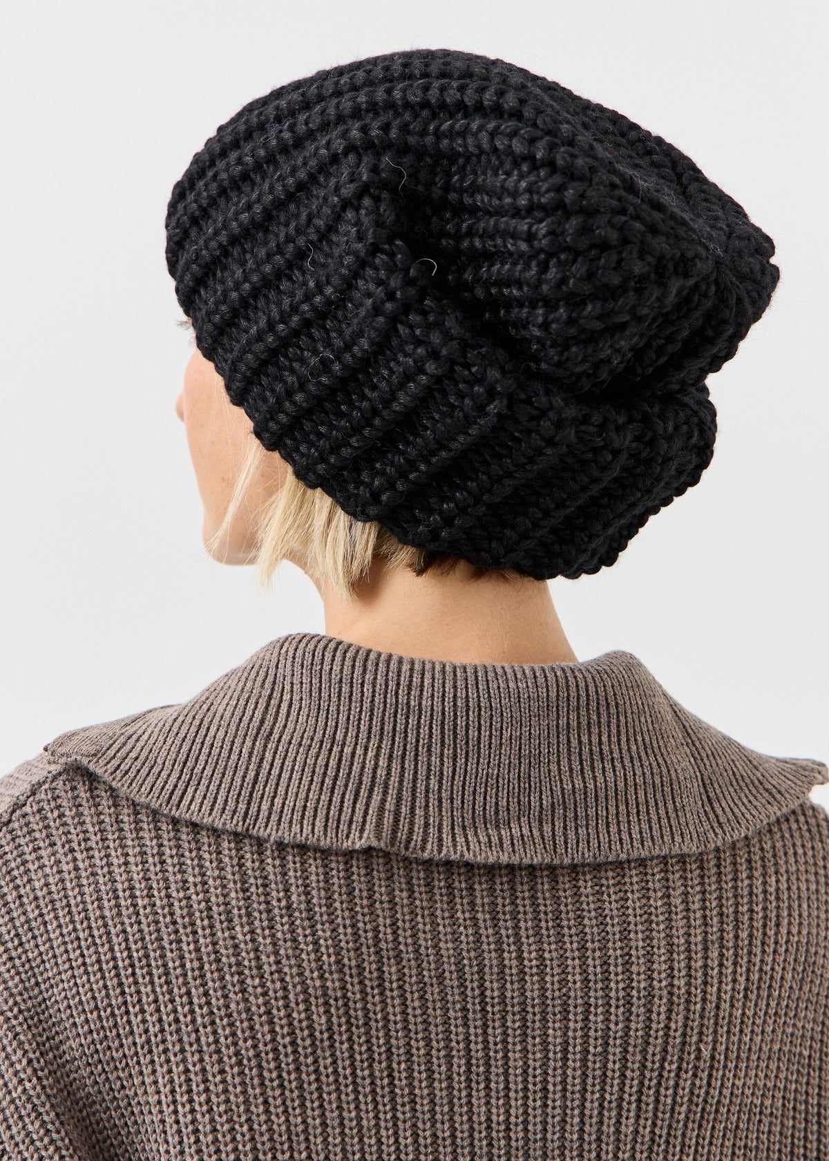 BRIKOLY Lustre Black Melange oversized knit beanie shown from the rear side.