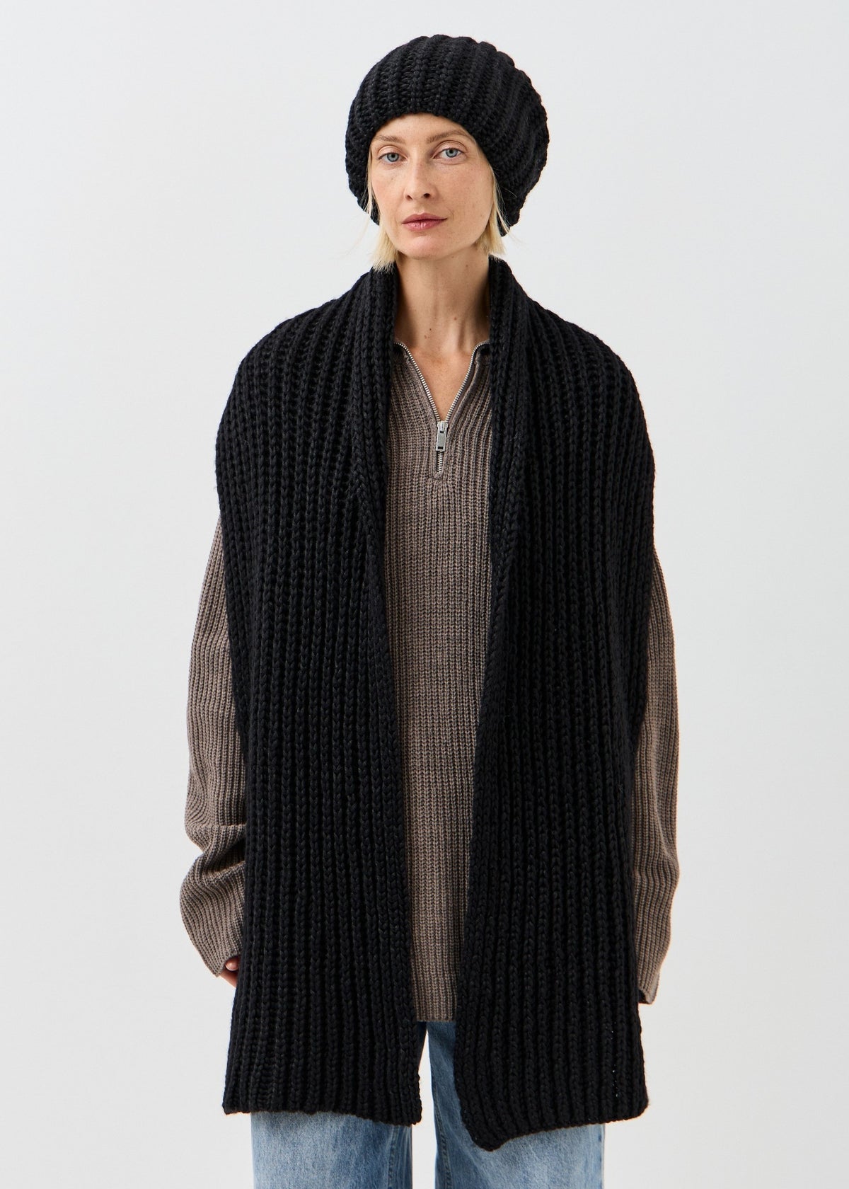 BRIKOLY Lustre Black Melange oversized knit beanie shown with a matching scarf hanging down the front.