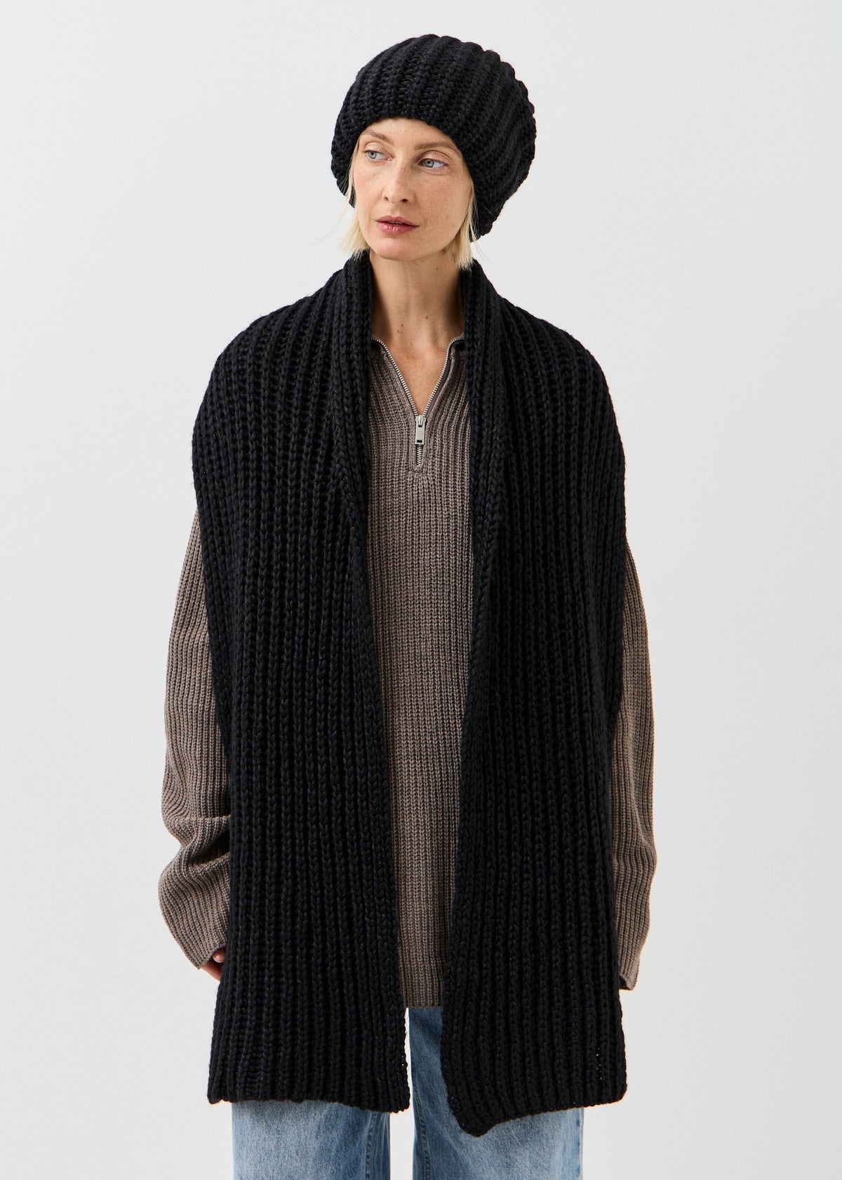 BRIKOLY Lustre Black Melange oversized knit beanie styled with a long matching scarf on a model.
