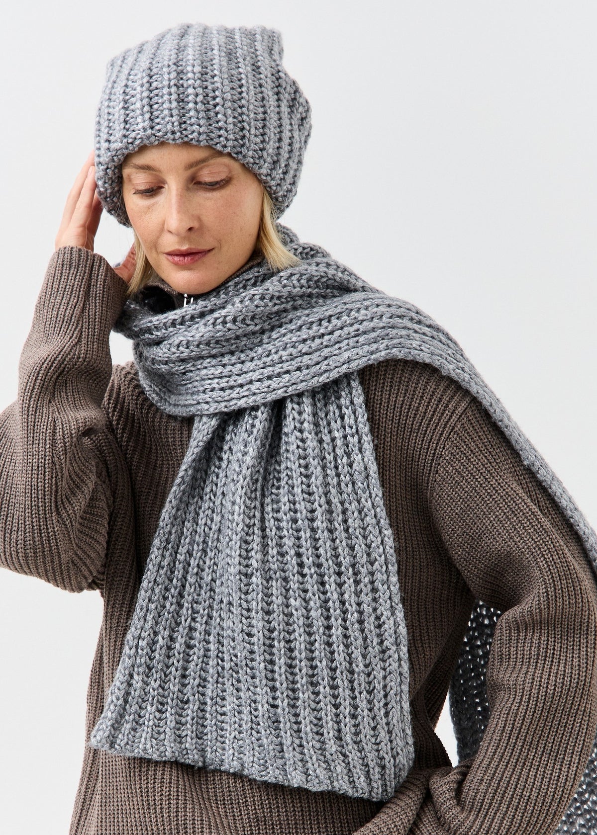 BRIKOLY Lustre Gray Melange knit scarf wrapped around a model's neck with one end hanging down.