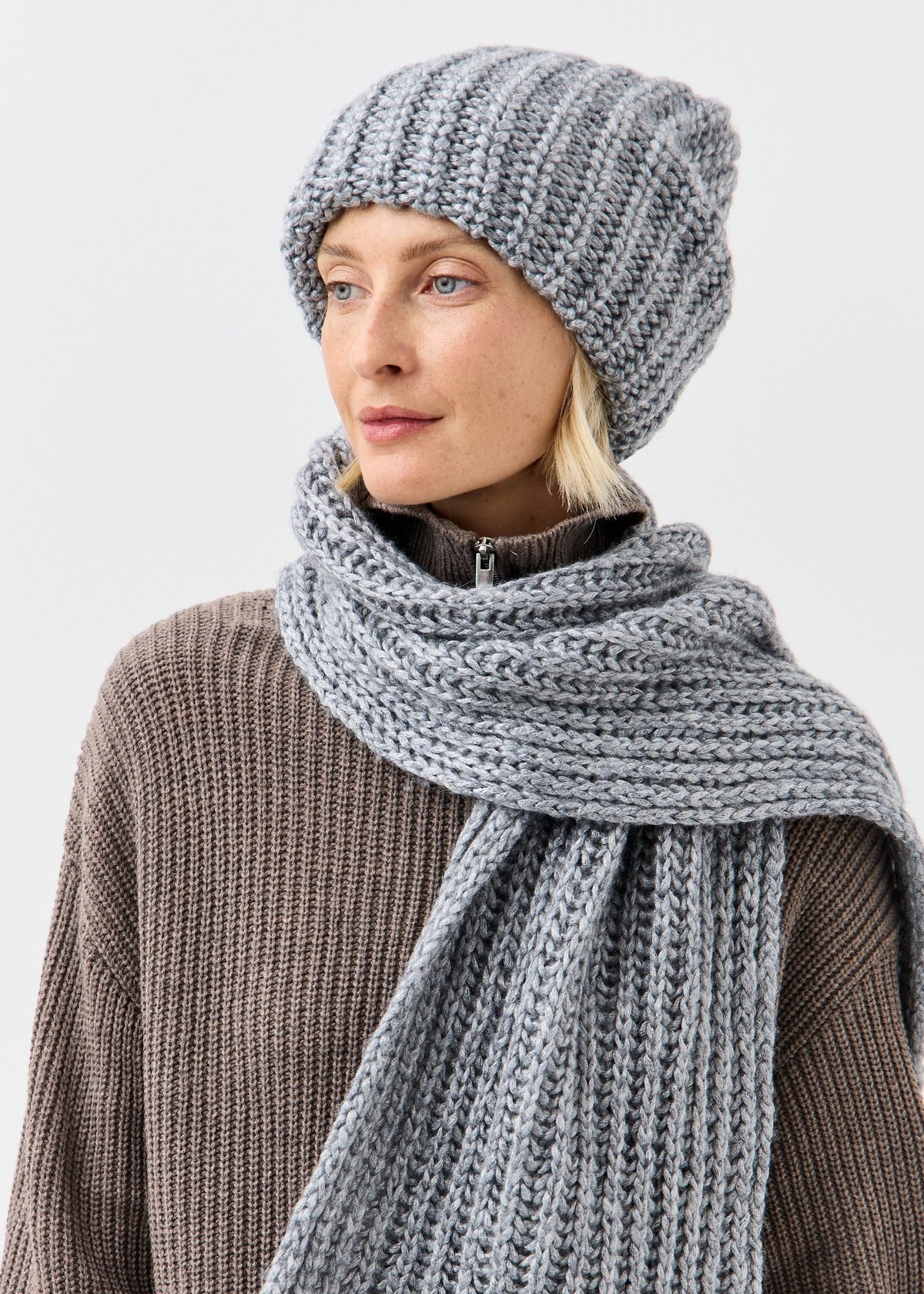 BRIKOLY Lustre Gray Melange knit scarf shown close up to reveal the ribbed texture.