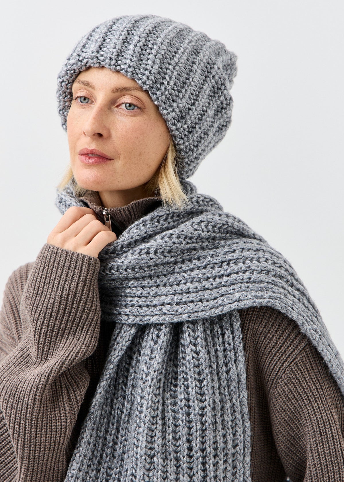 BRIKOLY Lustre Gray Melange knit scarf shown in a close front view on a model.