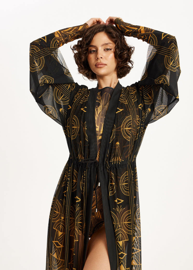 Woman wearing a black and gold patterned swimwear SPF-50 on a white background