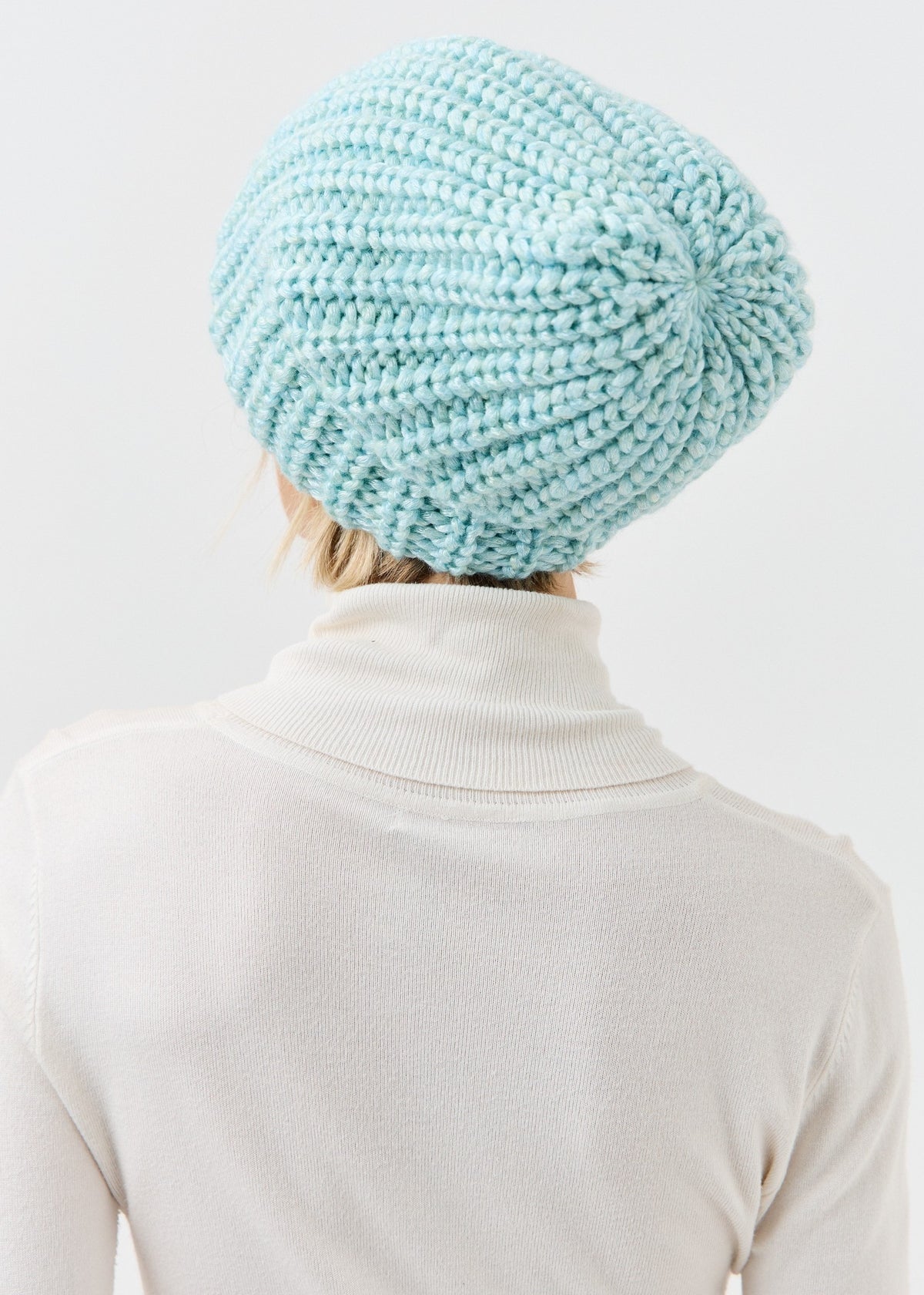 Back view of the Lustre Blue Melange beanie showing gathered knit crown