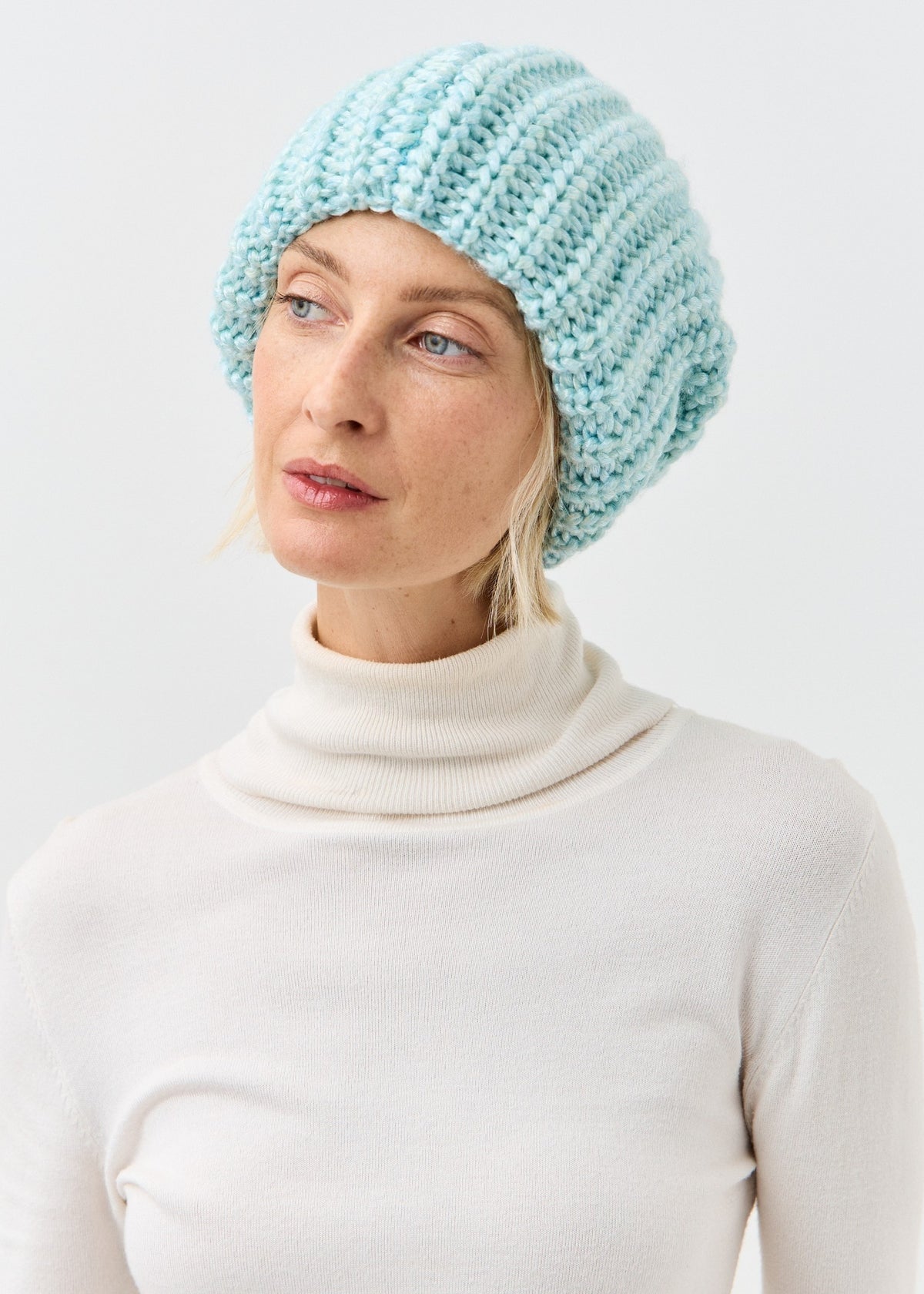 Front three-quarter view of the Lustre Blue Melange oversized beanie
