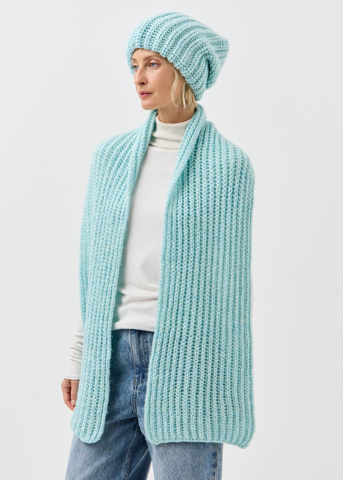 Lustre Blue Melange alpaca-wool scarf: Three-quarter outfit view with long ends hanging down; beanie sold separately