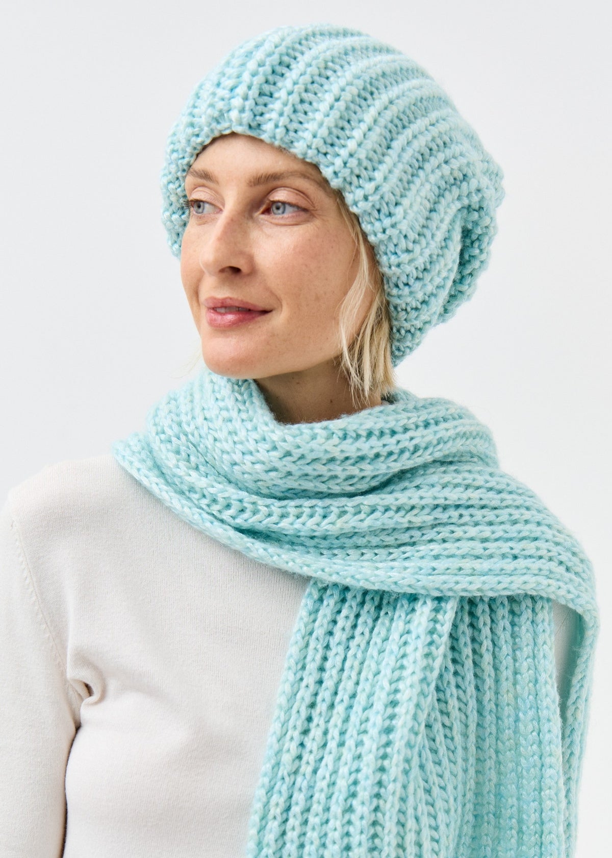 Lustre Blue Melange alpaca-wool scarf: Three-quarter portrait showing the long ribbed end; beanie sold separately