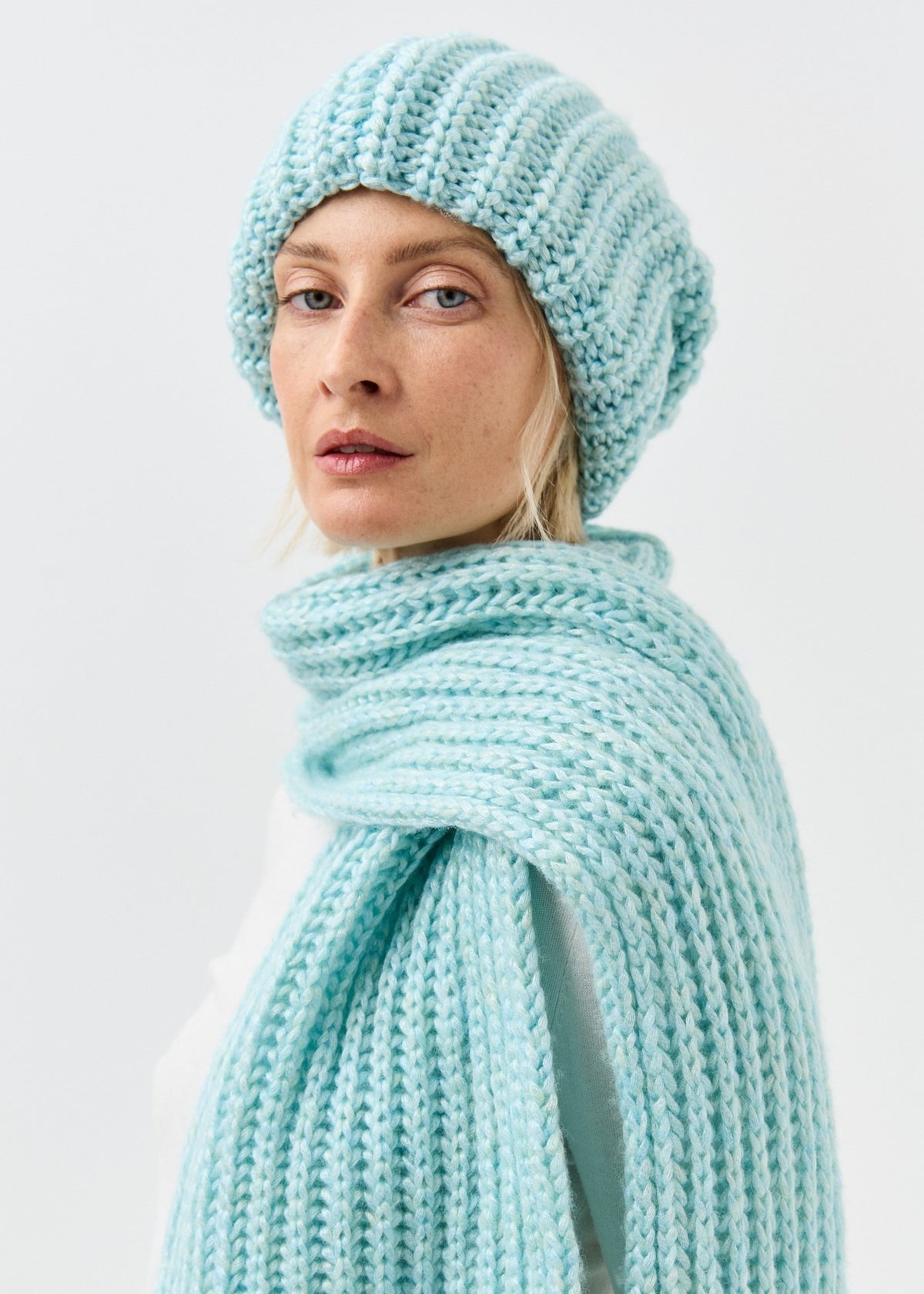 Front close-up of the Lustre Blue Melange beanie and matching scarf, sold separately