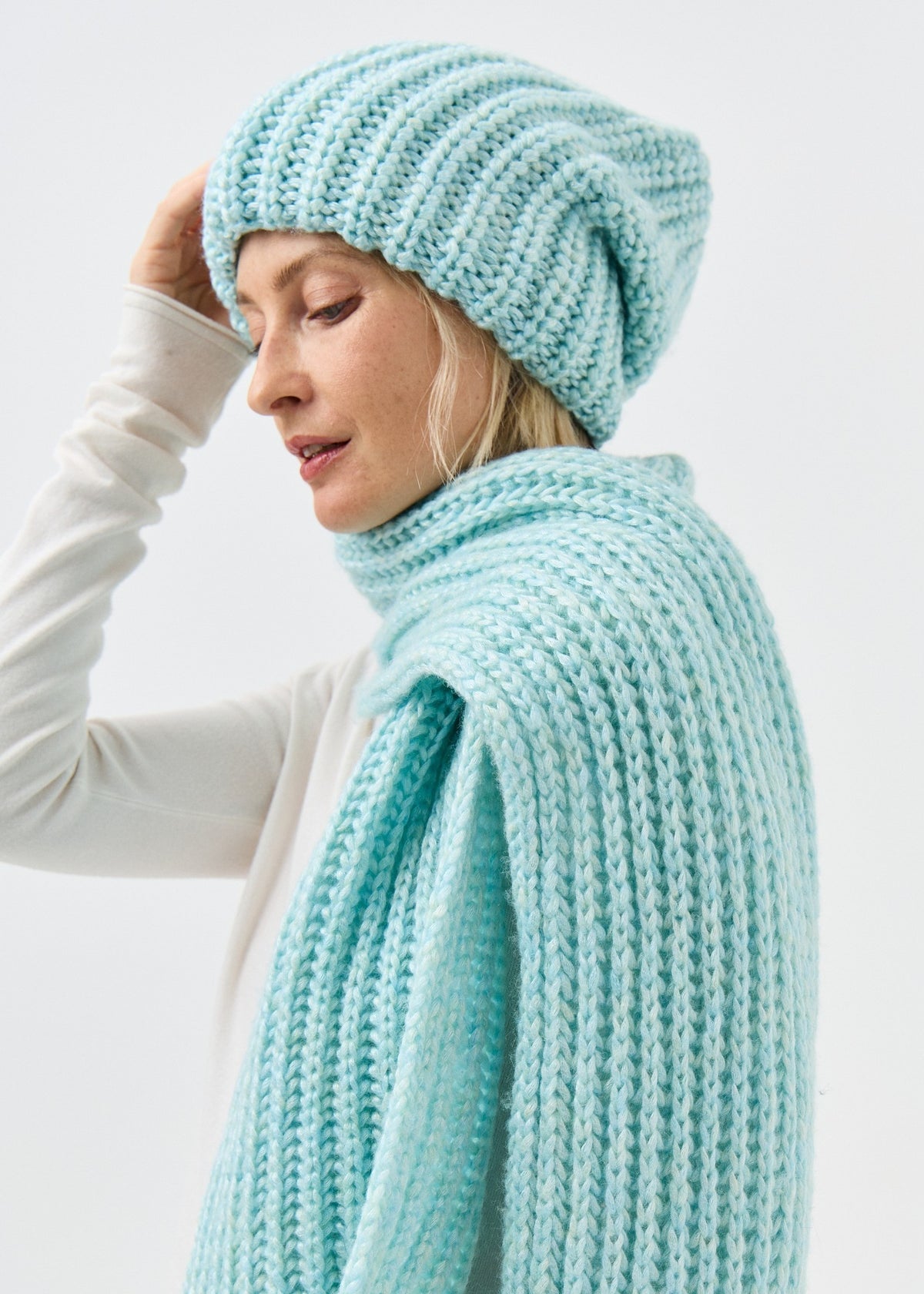 Lustre Blue Melange alpaca-wool scarf: Side close-up showing knit over the shoulder; beanie sold separately