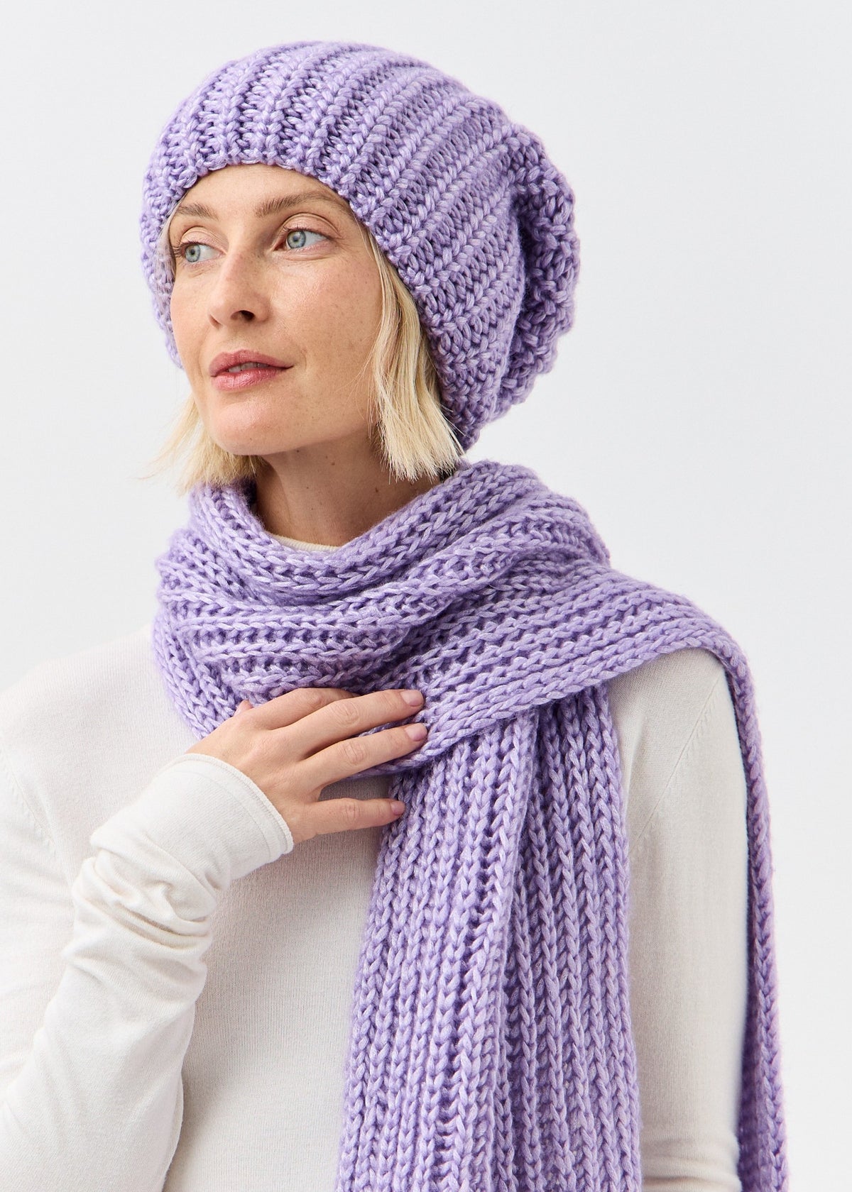 Lustre Violet Melange alpaca-wool scarf: Three-quarter close-up with a hand at the scarf; beanie sold separately