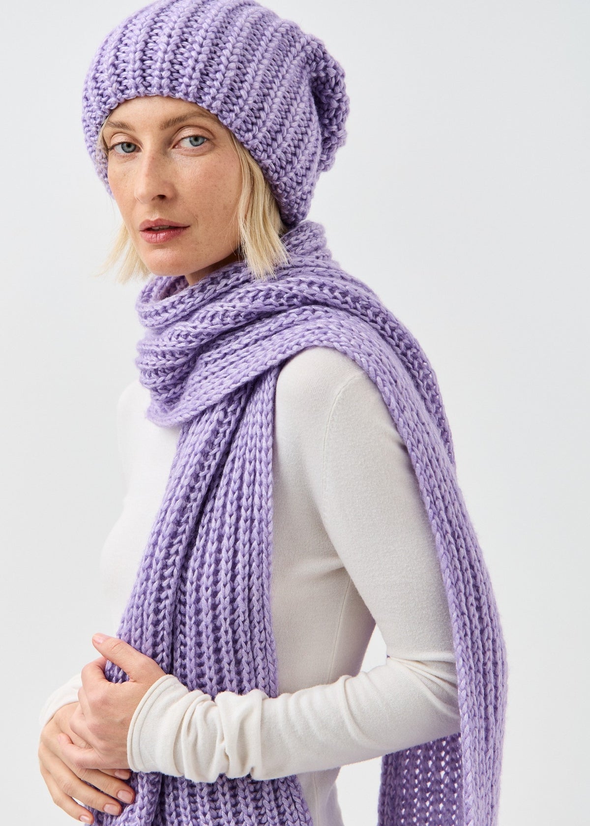 Lustre Violet Melange alpaca-wool scarf: Three-quarter portrait showing long scarf end; beanie sold separately