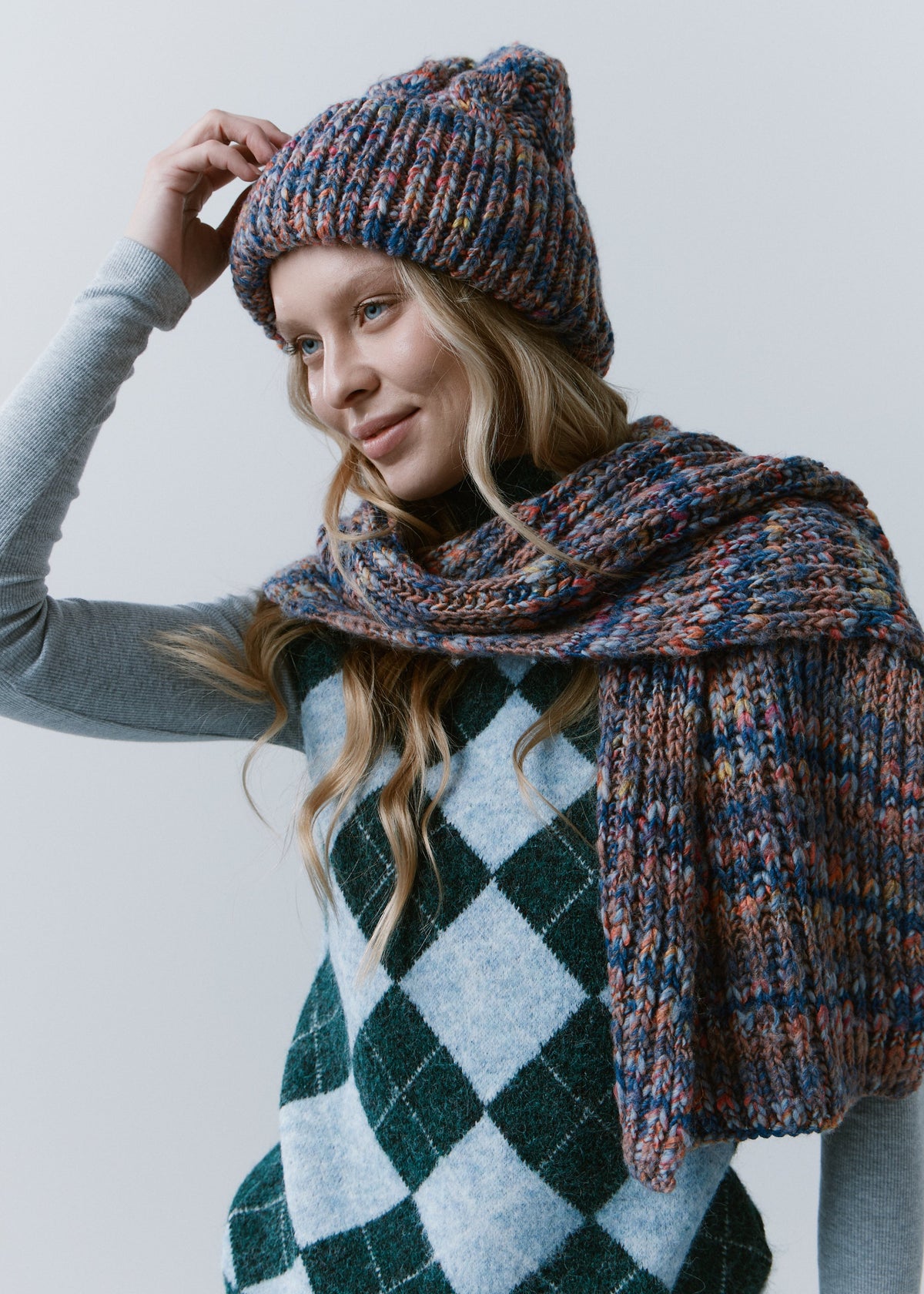 Tokyo Pink and Blue cable knit wool beanie: Portrait with matching scarf and a hand at the crown, sold separately