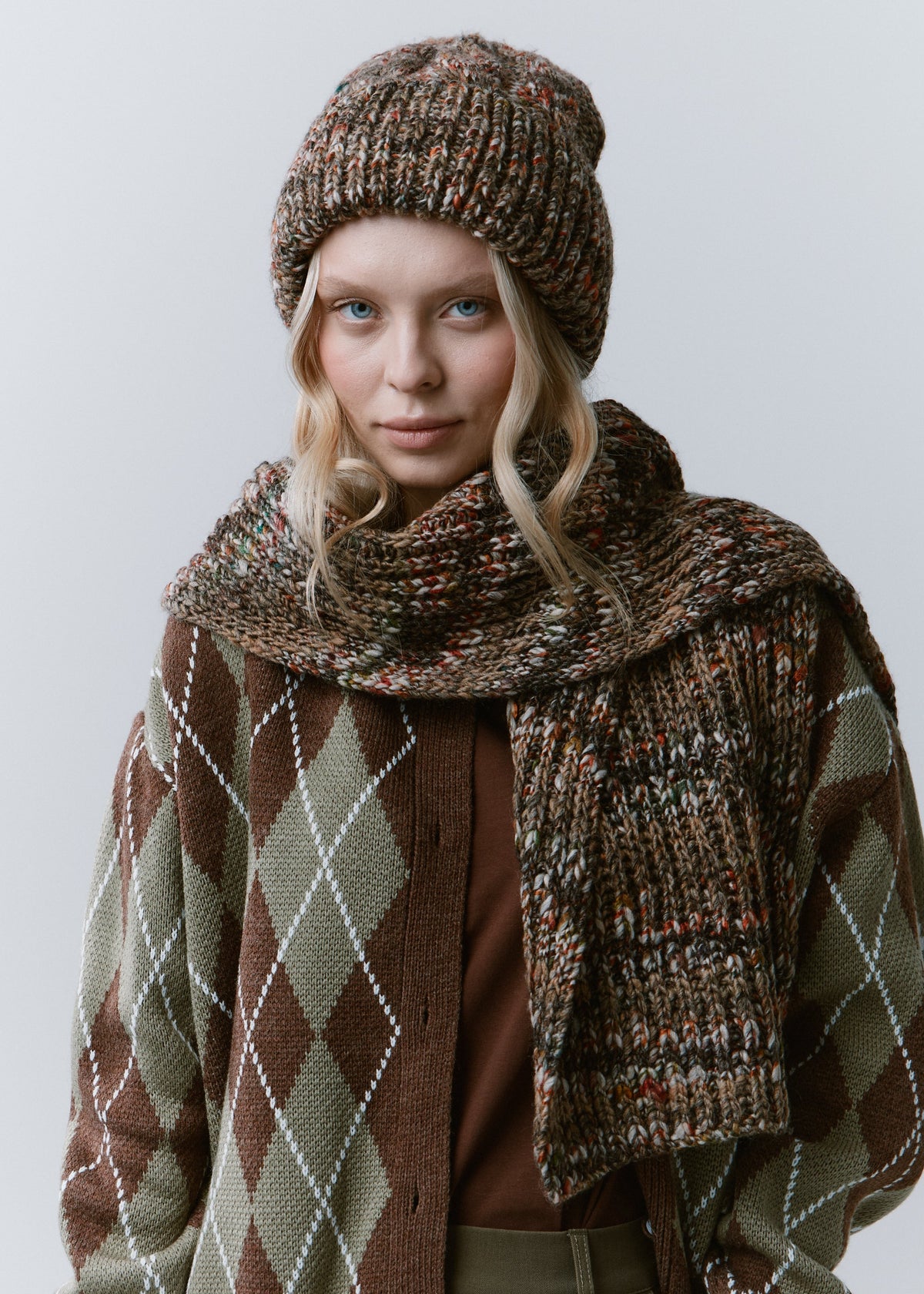 Tokyo Multicolor cable knit wool beanie: Front portrait with matching scarf wrapped at the neck, sold separately