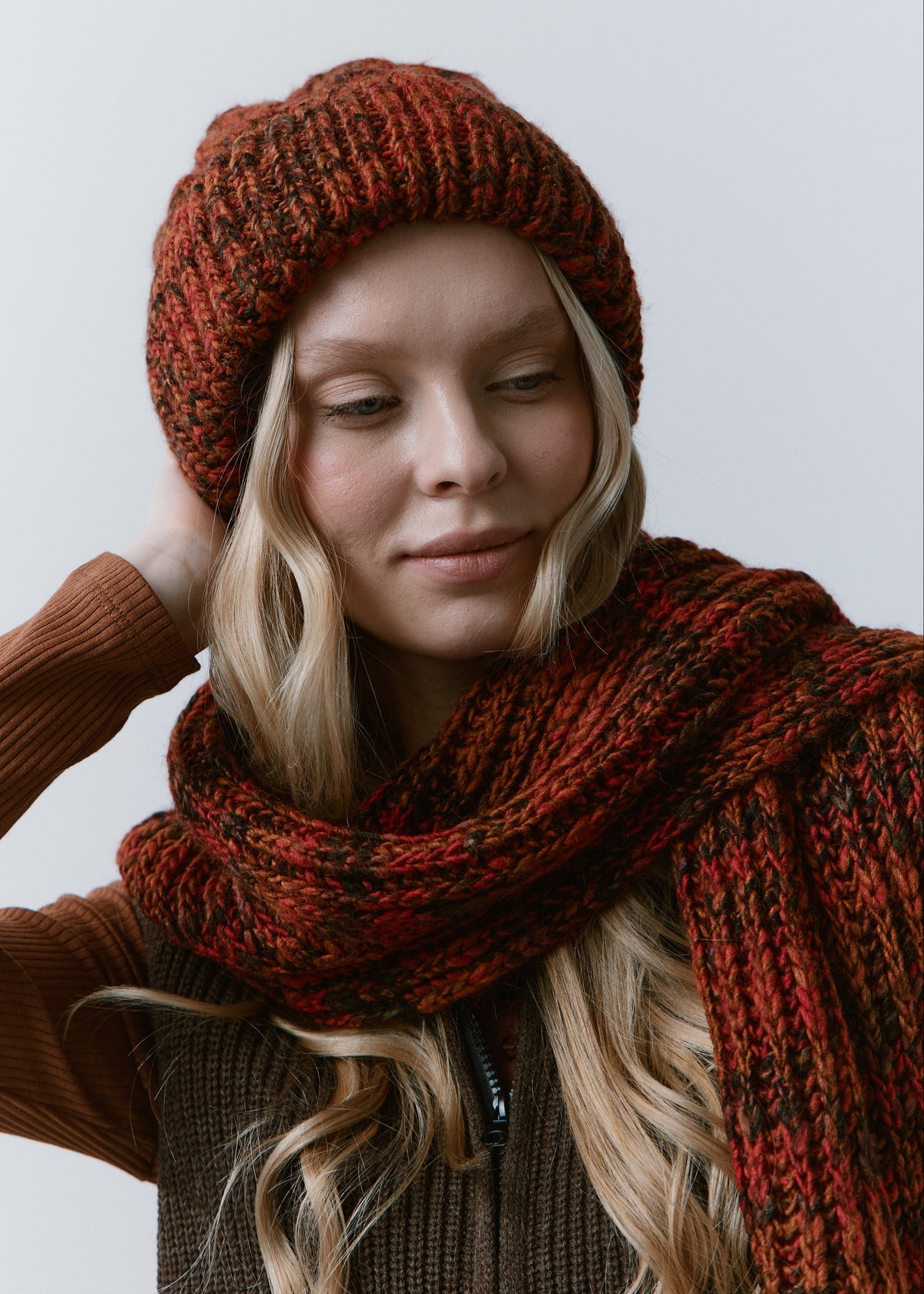 Tokyo Brown cable knit wool beanie: Close-up with matching scarf and a hand behind the head, sold separately