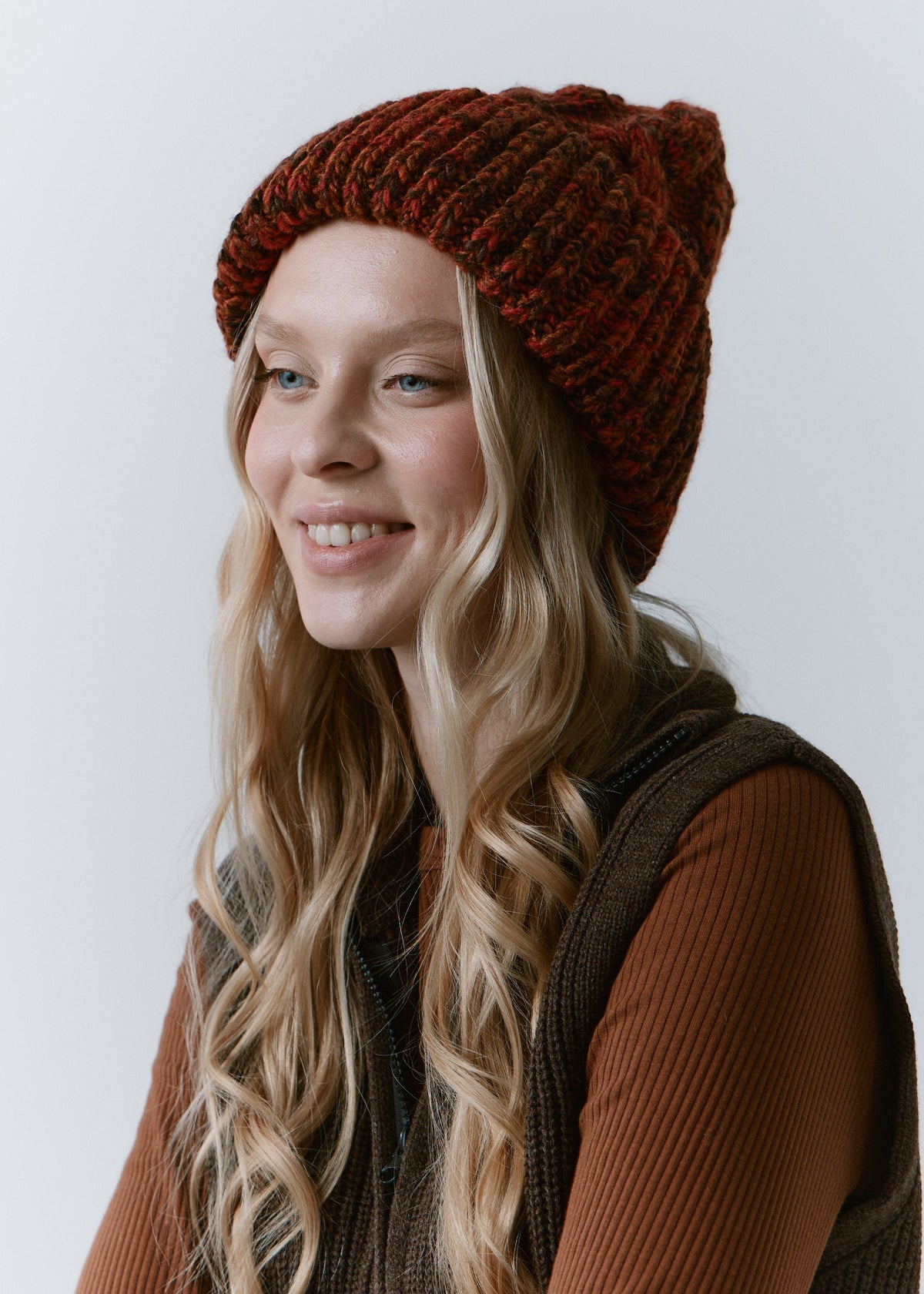 Tokyo Brown cable knit wool beanie: Three-quarter smiling portrait