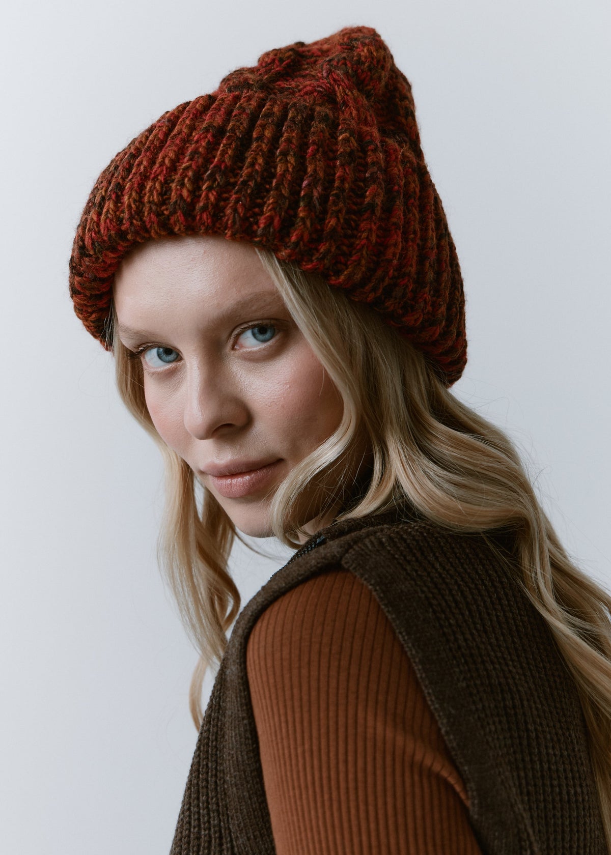 Tokyo Brown cable knit wool beanie: Three-quarter portrait showing the folded cuff