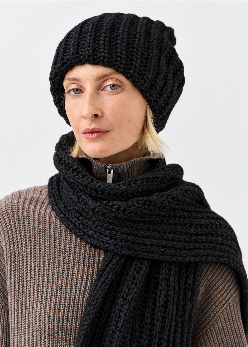 BRIKOLY Lustre Black Melange oversized knit beanie shown in a close front view with a matching scarf.