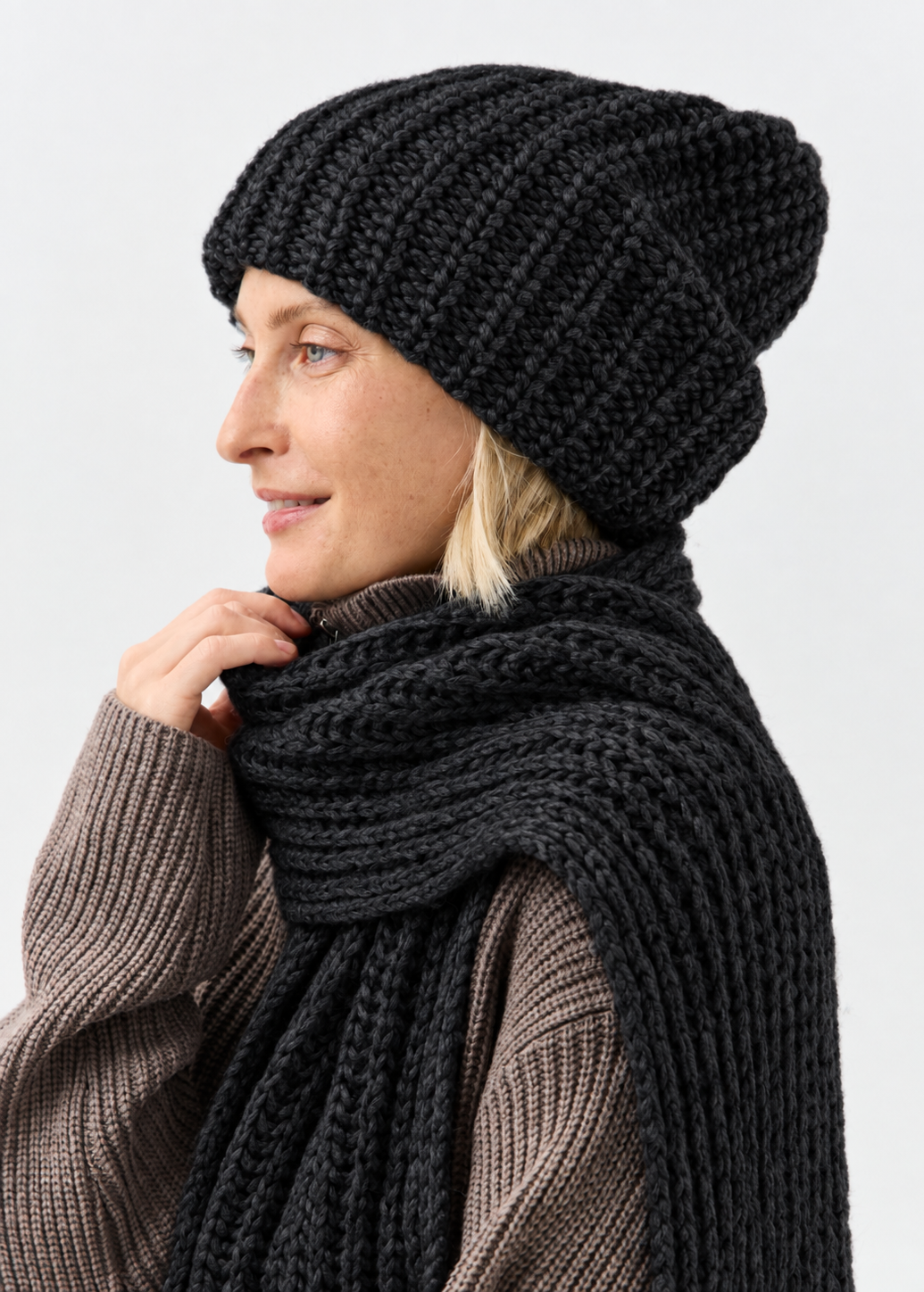 Lustre Black Melange alpaca-wool scarf: Side smiling portrait; beanie sold separately