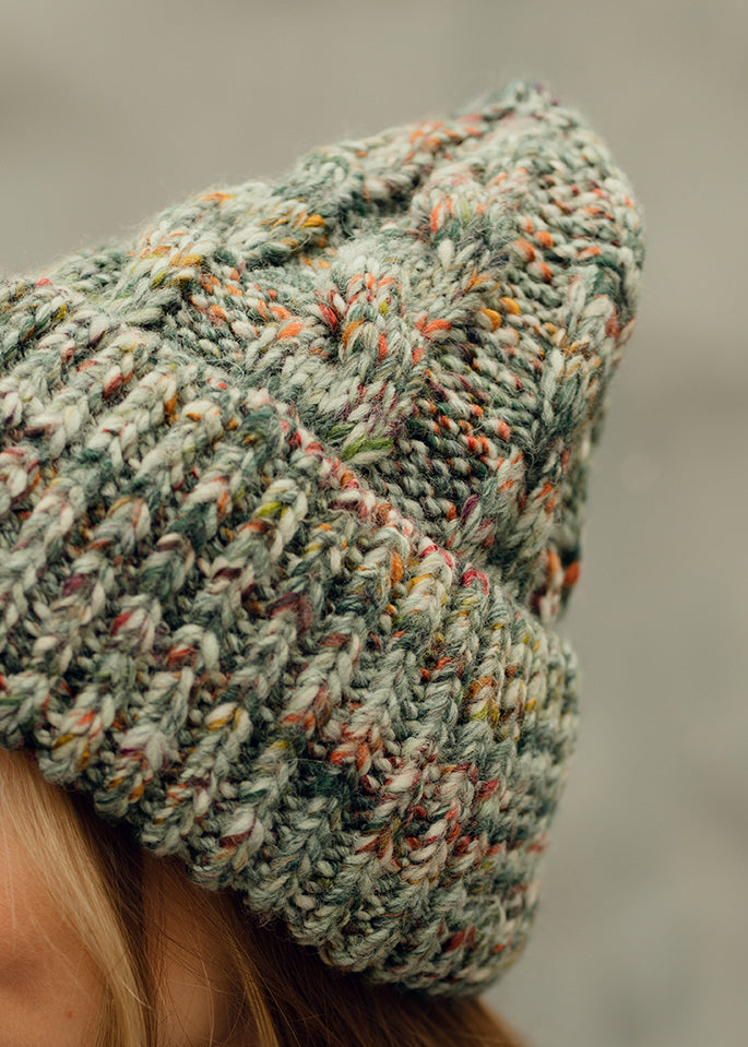Tokyo Green cable knit wool beanie: Side close-up of the cable knit texture