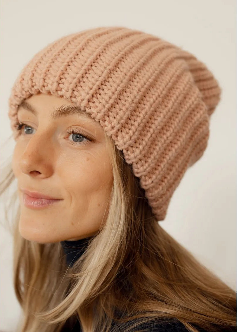 BRIKOLY London Peach knit beanie shown in a close side view.
